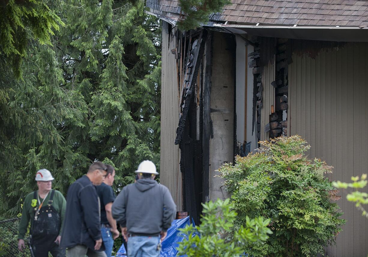 Firefighters and onlookers gather at the First Congregational United Church of Christ after a fire damaged the building Wednesday morning in Hazel Dell.