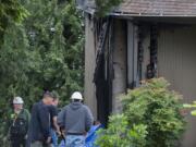 Firefighters and onlookers gather at the First Congregational United Church of Christ after a fire damaged the building Wednesday morning in Hazel Dell.