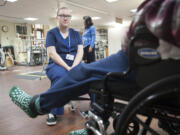 Savannah Rhinevault, 17, a senior at Henrietta Lacks Health and Bioscience High School, watches a patient move his weighted feet during her internship in the physical therapy department at the Vancouver Veterans Affairs campus.