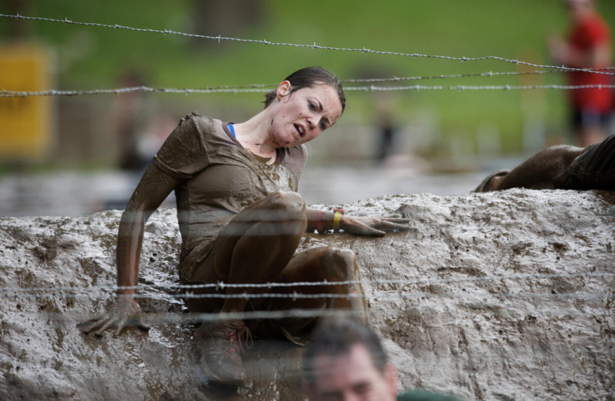 Thousands of people brave mud and barbed wire to take part in the Spartan Sprint at the Washougal MX Park track in Washougal.