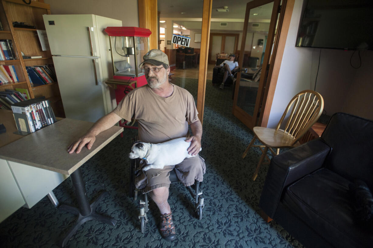 Army veteran and Central Park Place resident Bob Ewing talks about living at the low-income apartment complex in west Vancouver, as his dog, Trix, relaxes on his lap.