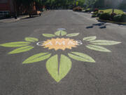 Camas: Camas High School students and members of the Downtown Camas Association painted a street emblem at the bordering streets of the farmers market that was designed by Brianna Cloutier, a member of Camas&#039; Integrated Arts and Academics program.