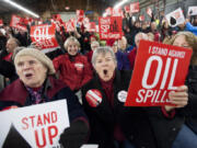 Maureen Hildreth, center, voices her opposition to the building of an oil transfer terminal at a rally at a Jan. 5 hearing in Vancouver. Hundreds gathered that afternoon at the Clark County Event Center at the Fairgrounds to offer testimony on the proposed rail-to-marine oil terminal at the Port of Vancouver.