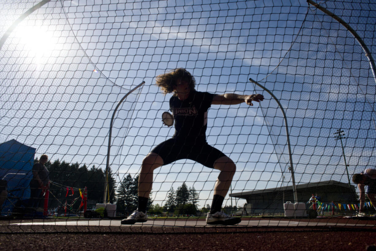 Union senior Bailey King hurls a discus during the final day of the Greater St. Helens 4A district championship track meet at McKenzie Stadium in Vancouver on Friday, May 13, 2016.