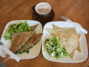 A bacon, spinach and tomato crepe, left, and a French club crepe, right, are served May 4 with a Dragonfly Chai at Mon Ami restaurant in Vancouver&#039;s Uptown Village.