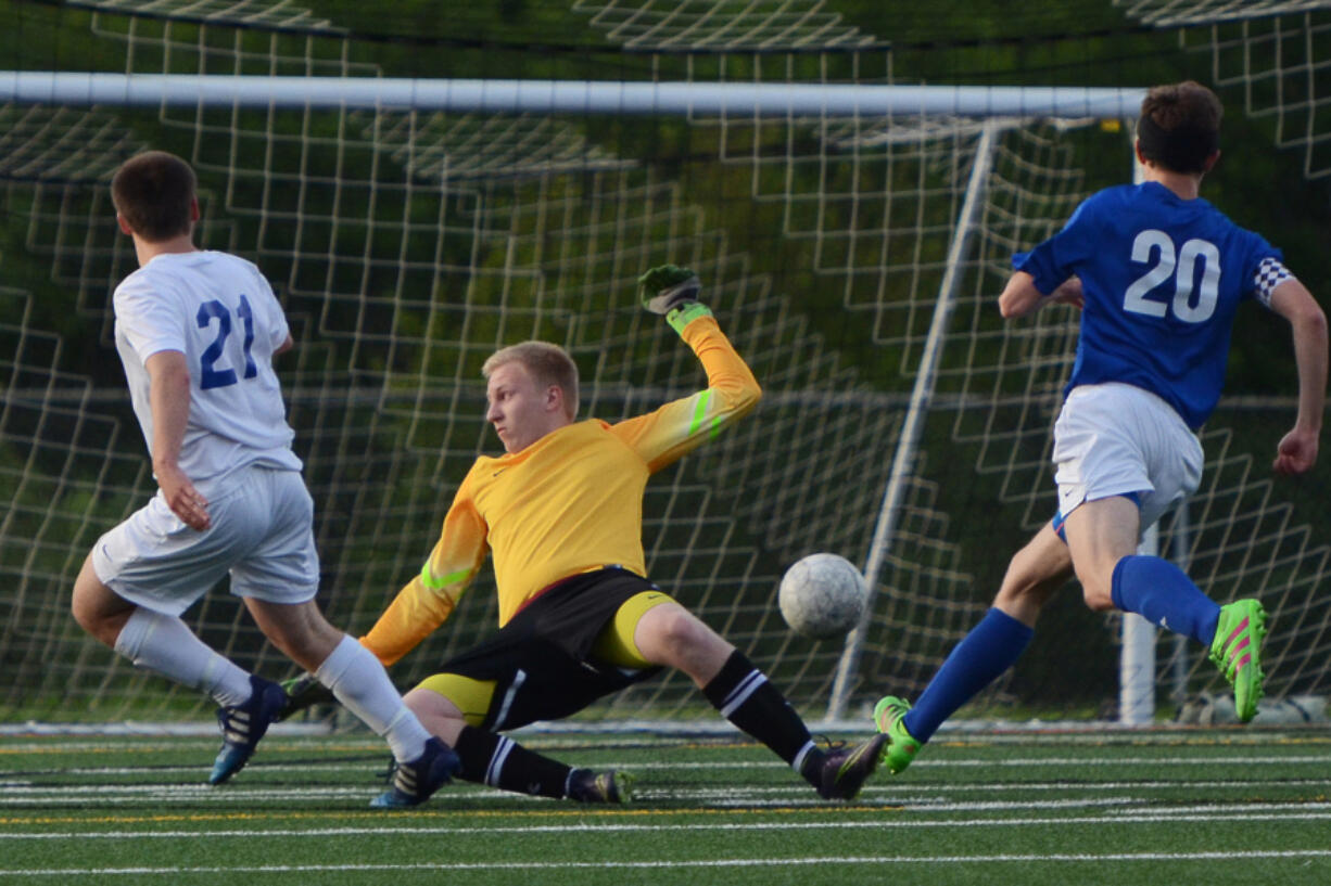 Ridgefield junior Jason Osborn (21) scores the first goal of the game past Liberty goaltender Austin Surber.