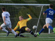 Ridgefield junior Jason Osborn (21) scores the first goal of the game past Liberty goaltender Austin Surber.