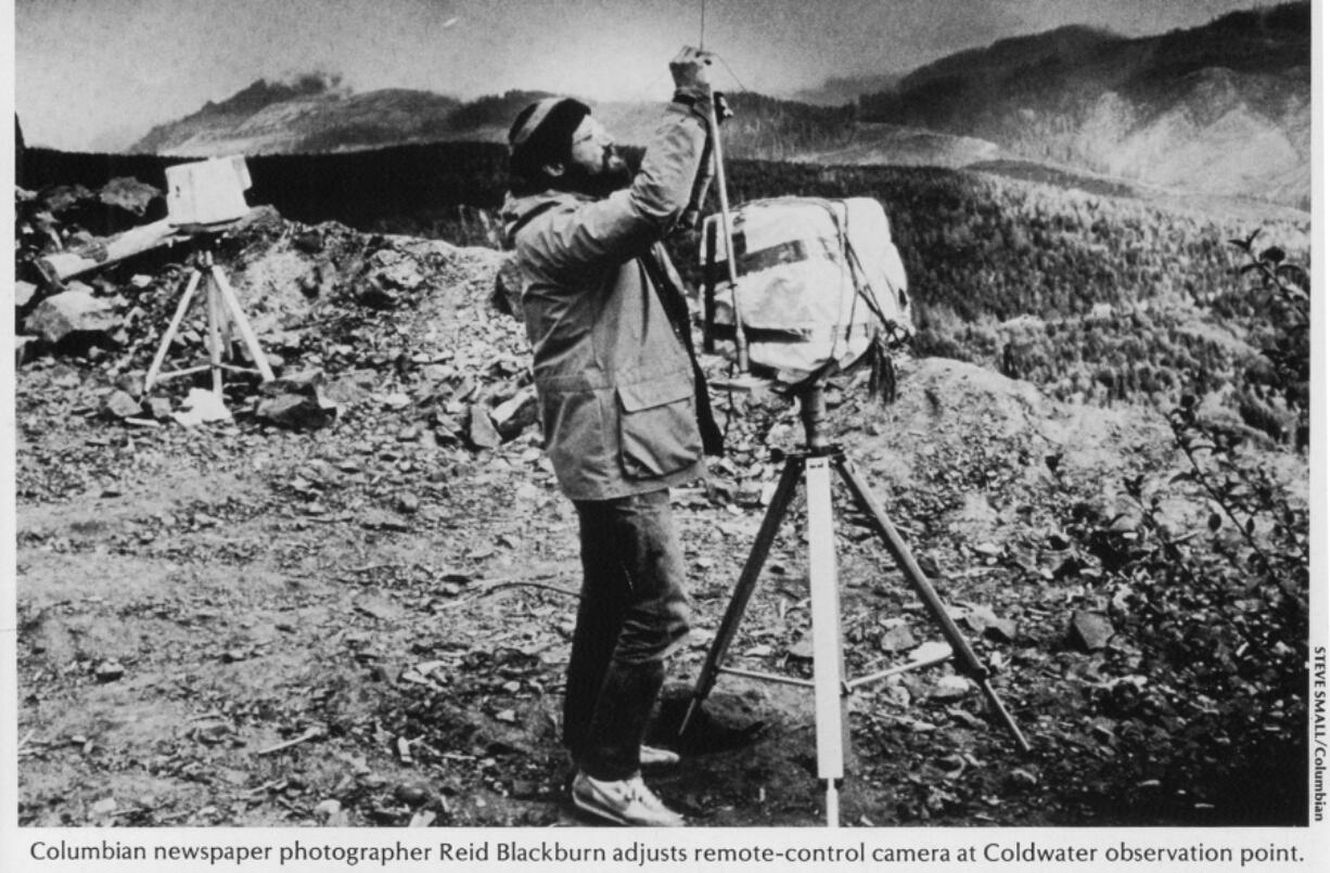 Columbian photographer Reid Blackburn adjusts one of two remote-controlled cameras on Mount St. Helens in 1980.