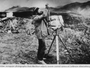 Columbian photographer Reid Blackburn adjusts one of two remote-controlled cameras on Mount St. Helens in 1980.