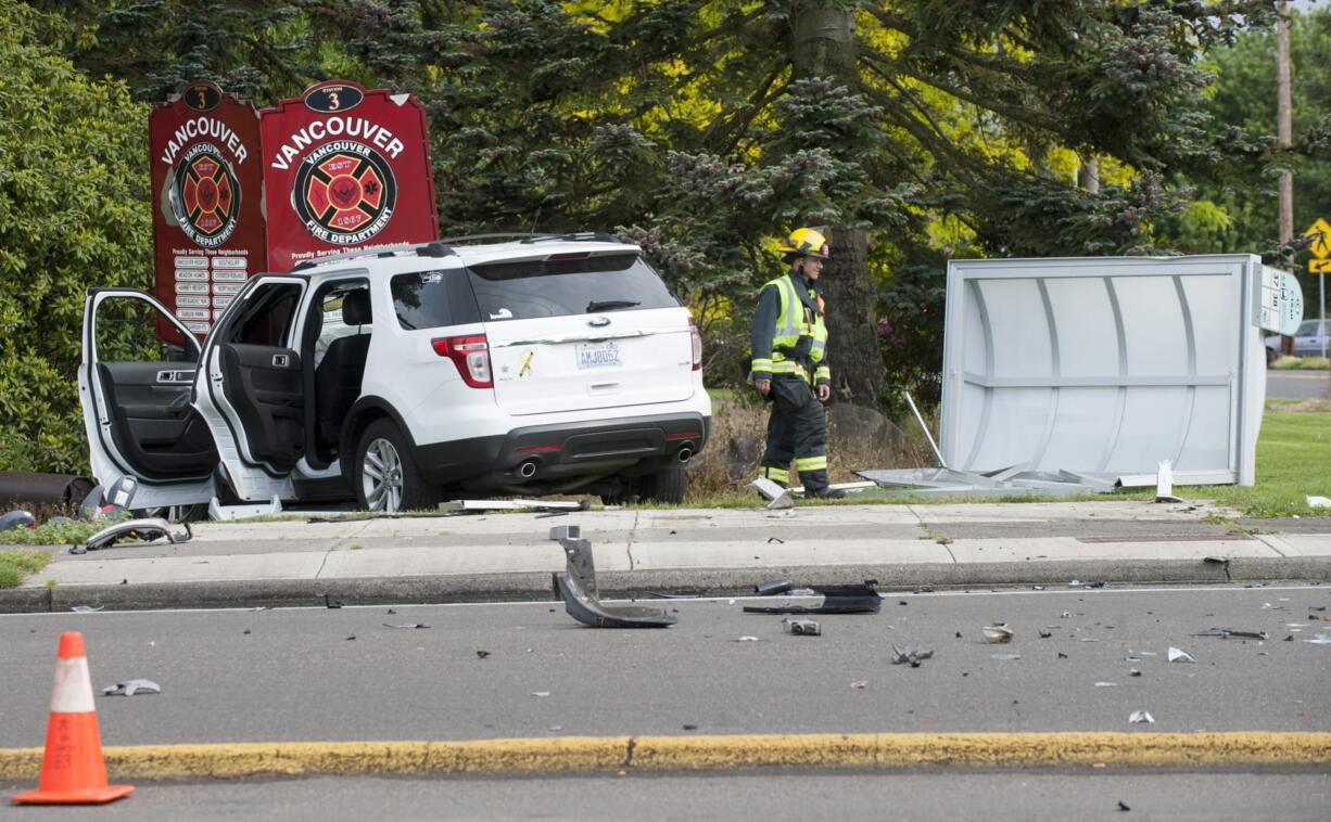 A fireman surveys the scene of a crash on Milll Plain and Devine St.