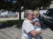 Candy Harrison of Battle Ground embraces her grandson, Pauly D. Harrison, 22 months, as she mourns the loss of Jose "Pepe" Castillo-Cisneros, 3, Tuesday afternoon in Battle Ground.