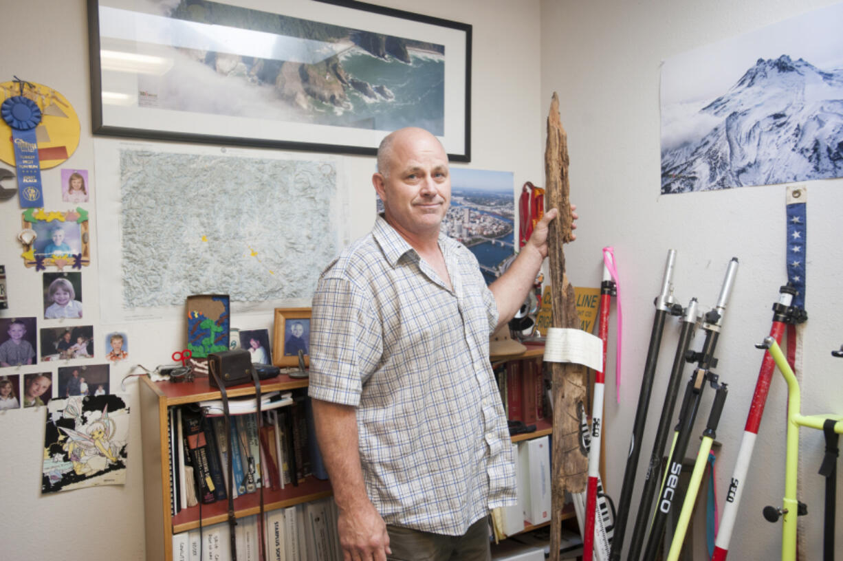 Surveyor Dan Renton holds a &quot;bearing tree scribe&quot; in his Vancouver office Tuesday.