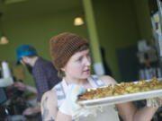 Alex Yost, co-owner of OurBar in Washougal, racks a tray of breakfast potatoes. She said she and her husband were pulled into Washougal's "tractor beam of light" when they decided to move to Portland three-plus years ago.