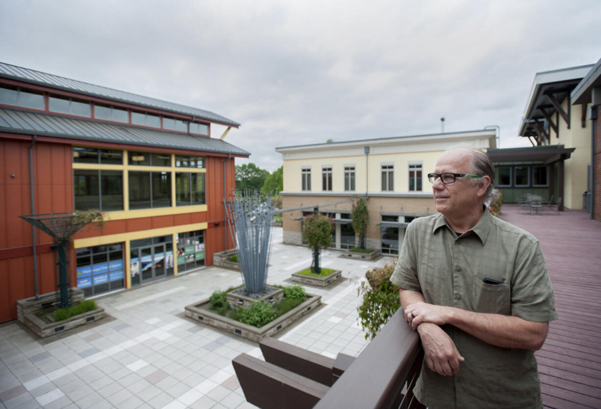 Wes Hickey of Lone Wolf Investments looks out over the courtyard of Washougal Town Square, the building on Main Street He constructed that has retail and office space and a landscaped public plaza.