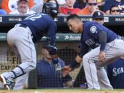 Seattle Mariners' Robinson Cano, left, celebrates his solo home run off of Houston Astros starting pitcher Dallas Keuchel with Leonys Martin in the third inning of a baseball game against the Houston Astros, Saturday, May 7, 2016, in Houston.