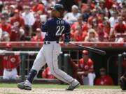 Seattle Mariners' Robinson Cano hits an RBI-sacrifice fly off Cincinnati Reds starting pitcher Alfredo Simon to drive in Leonys Martin in the fifth inning of a baseball game, Sunday, May 22, 2016, in Cincinnati.