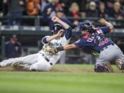 Seattle Mariners' Seth Smith, left, is tagged out at home plate by Minnesota Twins catcher Juan Centeno during the sixth inning of a baseball game  Saturday, May 28, 2016, in Seattle.