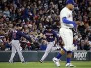 Seattle Mariners starting pitcher Taijuan Walker, right, returns to the mound as Minnesota Twins' Robbie Grossman (36) is congratulated by third base coach Gene Glynn on Grossman's home run in the second inning of a baseball game Sunday, May 29, 2016, in Seattle.