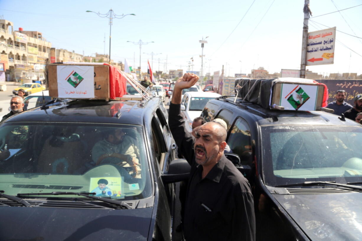 Mourners carry the coffins of two men killed Friday in protests outside Baghdad&#039;s Green Zone during their funeral procession Saturday in Baghdad.