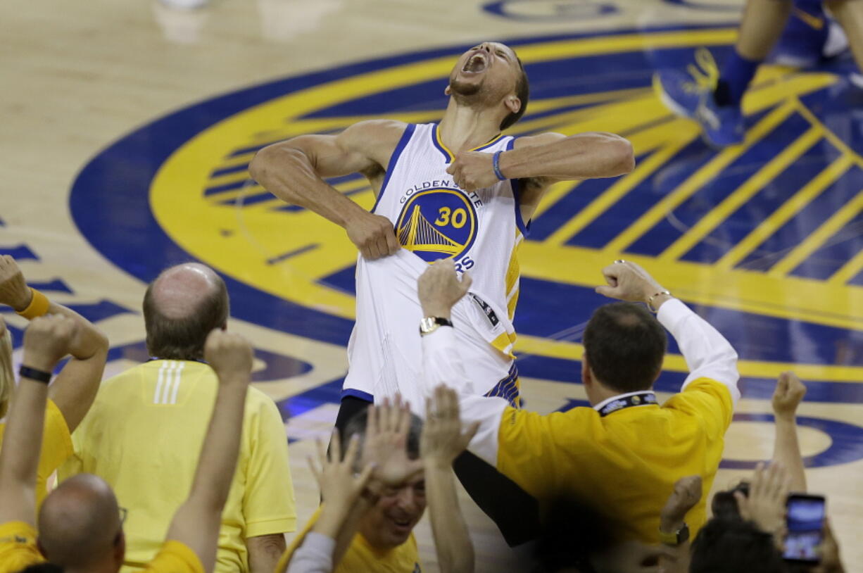 Fans cheer as Golden State Warriors guard Stephen Curry yells after the Warriors beat the Oklahoma City Thunder in Game 7 of the NBA basketball Western Conference finals in Oakland, Calif., Monday, May 30, 2016. The Warriors won 96-88.