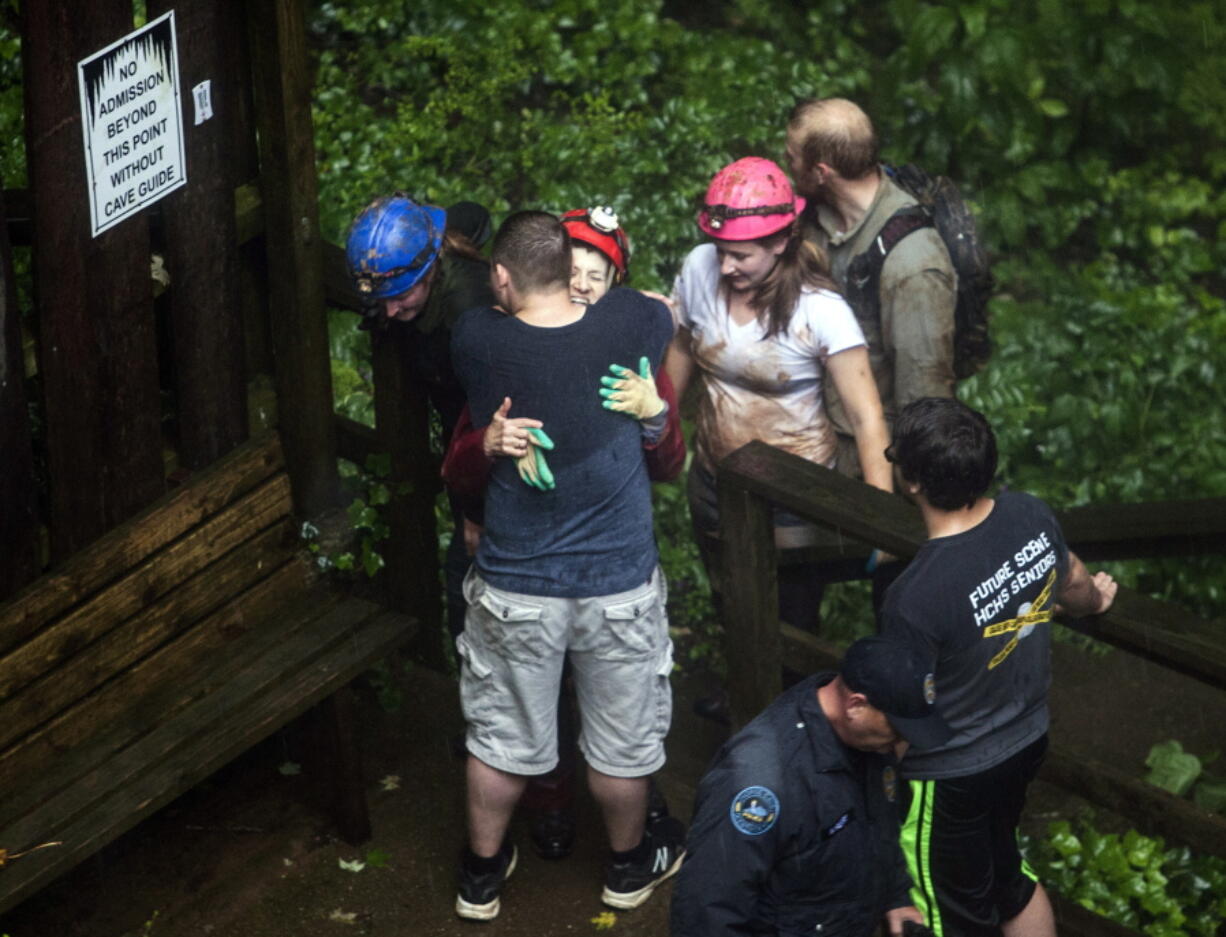 Tour guide Peggy Nims hugs a friend after she made it out of Hidden River Cave on Thursday. Nineteen people were trapped due to flash flooding in Horse Cave, Ky.