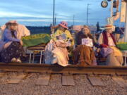 Members of the Seattle Raging Grannies sit in their rocking chairs chained together on the Burlington-Northern Railroad tracks at Farm to Market Road in Skagit County on Friday evening, May 13, 2016, in Burlington, Wash.  From left are Deejay Sherman Peterson, Anne Thureson, Shirley Morrison and Rosy Betz-Zall. Hundreds of people in kayaks and on foot are gathering at the site of two oil refineries in Washington state to call for action on climate change and a fair transition away from fossil fuels.