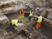 Archaeologists work on the exposed remains as the site of Shakespeare&#039;s Curtain Theatre is excavated in Shoreditch in London, Tuesday, May 17, 2016.  Archaeologists are excavating the remains of the Curtain, a 16th-century theater where some of the Bard&#039;s play&#039;s were staged, before another gleaming tower joins the city&#039;s crowded skyline.