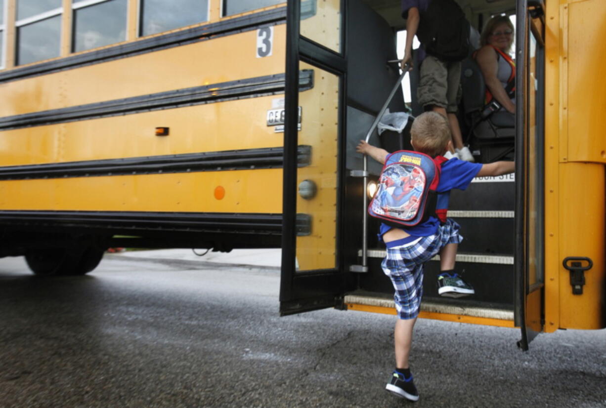 A student at Indian Lake Elementary in Kalamazoo, Mich., boards a bus Sept. 4, 2012. Bullying should no longer be dismissed as merely a matter of kids being kids, experts warned.