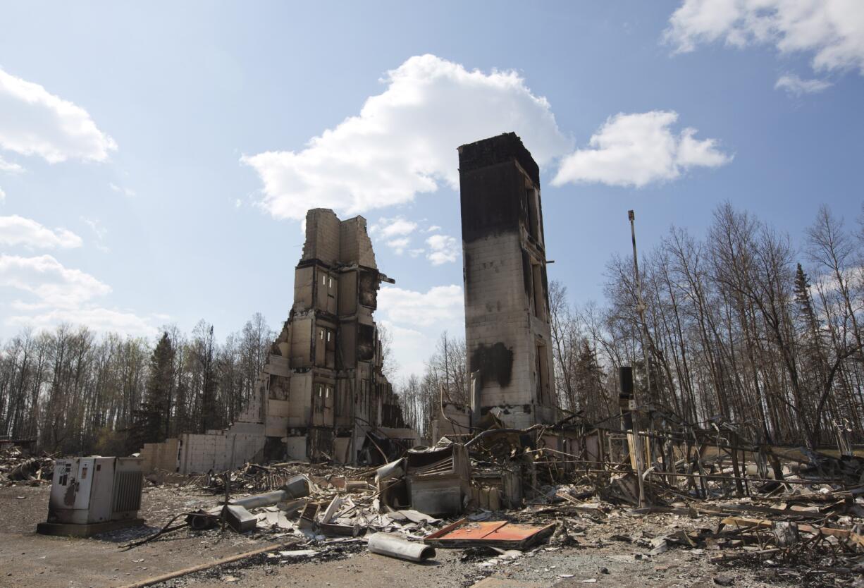 A burned building stands among charred rubble in the neighborhood of Abasand in wildfire-ravaged Fort McMurray, Alberta, on Friday, May 13, 2016.