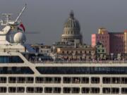 Passengers stand on Carnival&#039;s Adonia cruise ship as they arrive from Miami in Havana, Cuba, on Monday. The Adonia&#039;s arrival is the first step toward a future in which thousands of ships a year could cross the Florida Straits, long closed to most U.S.-Cuba traffic due to tensions that once brought the world to the brink of nuclear war.