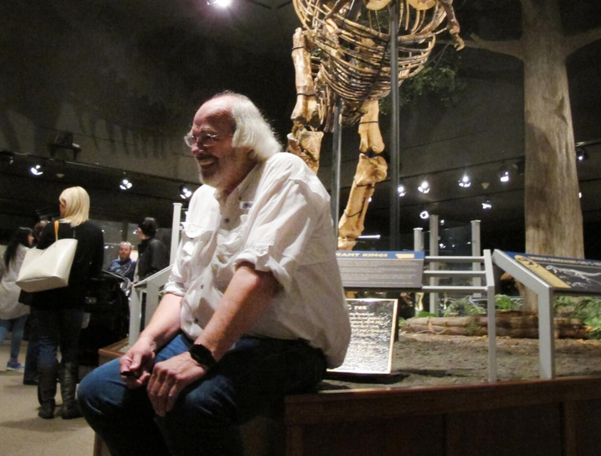 Jack Horner smiles as he sits under Montana&#039;s T Rex on May 21 in the Museum of the Rockies in Bozeman, Mont. Horner is retiring from the museum this summer.