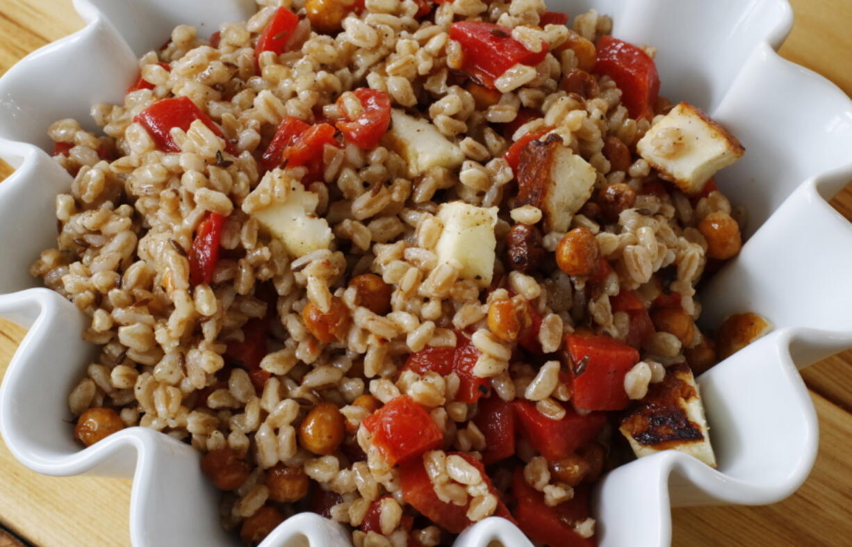 A chickpea and farro salad in Concord, N.H., combines savory roasted chickpeas with grilled halloumi cheese and nutty cooked farro for a light, but hearty spring salad. (AP Photo/J.M. Hirsch) (J.M.