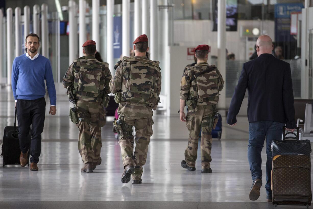 French soldiers patrol at Charles de Gaulle airport, outside of Paris, Friday, May 20, 2016. The search continued on Friday for missing EgyptAir flight 804, which disappeared from the radar while carrying 66 passengers and crew from Paris to Cairo.