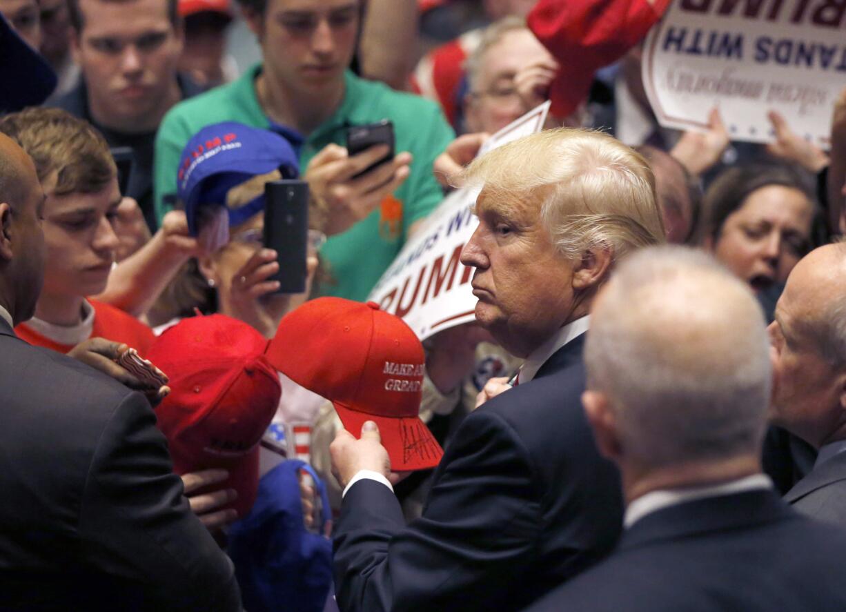 Republican presidential candidate  Donald Trump looks at the line of supporters as he works the crowd after a campaign stop Monday in South Bend, Ind. According to Sen. Don Benton, Trump will not come to Vancouver on Saturday.