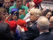 Republican presidential candidate  Donald Trump looks at the line of supporters as he works the crowd after a campaign stop Monday in South Bend, Ind. According to Sen. Don Benton, Trump will not come to Vancouver on Saturday.