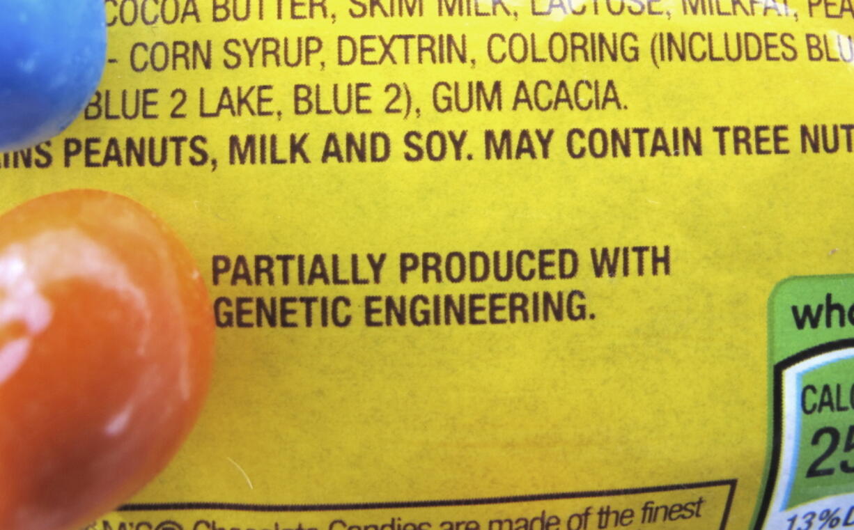 FILE - In this April 8, 2016 file photo, a new disclosure statement is displayed on a package of Peanut M&amp;M&#039;s candy in Montpelier, Vt., saying they are &quot;Partially produced with genetic engineering.&quot; Genetically manipulated food remains generally safe for humans and the environment, a high-powered science advisory board declared in a report Tuesday, May 17, 2016.