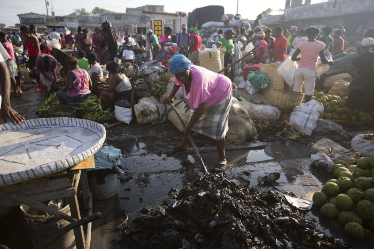 A vendor shovels rubbish away from her stand at a street market in Port-au-Prince, Haiti. New research suggests that the Zika virus has been present in Haiti since 2014. Dr. John Lednicky, a researcher at the University of Florida&#039;s Emerging Pathogens Institute, said it was still too early to tell if the mutating virus will cause the same serious consequences in Haiti as it has done in Brazil and other nations.