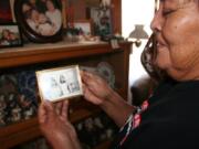 Mary Lowden holds a photo of her mother and her aunt, both pottery makers, during a visit to her home at Acoma Pueblo, N.M.