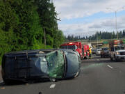 Traffic on Interstate 5 southbound is backed up after a rollover crash was reported this morning near Main Street. Troopers say that the preliminary investigation shows that a distracted driver caused the crash.