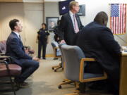 Former Cleveland Browns quarterback Johnny Manziel, left, sits while his defense attorneys confer with the prosecution during his initial hearing Thursday in Dallas. The Heisman Trophy winner and former Texas A&amp;M star was indicted by a grand jury last month after his ex-girlfriend alleged he hit her and threatened to kill her during a night out in January. No plea was entered, but defense attorney Robert Hinton says Manziel plans to plead not guilty. (Smiley N.