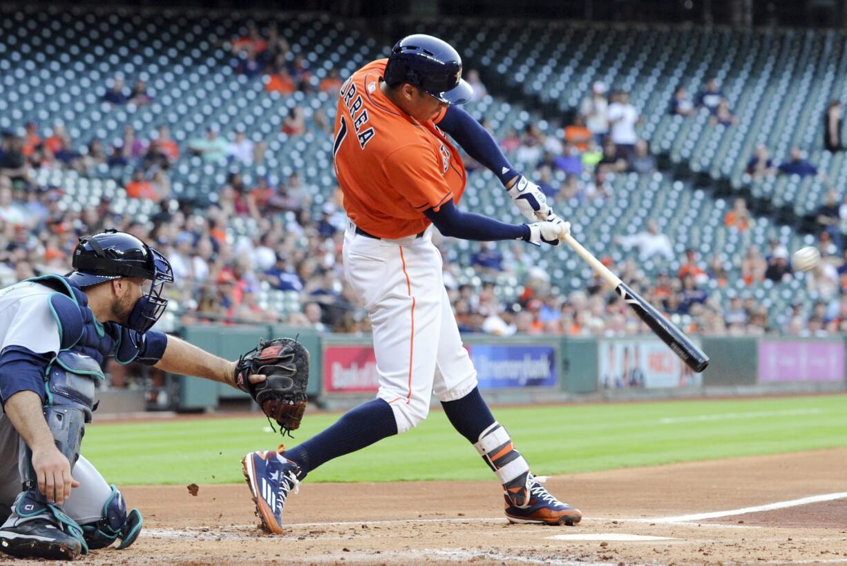 Houston Astros' Carlos Correa hits a solo home run off of Seattle Mariners starting pitcher Taijuan Walker in the first inning of a baseball game, Friday, May 6, 2016, in Houston.