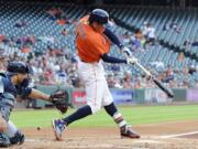 Houston Astros' Carlos Correa hits a solo home run off of Seattle Mariners starting pitcher Taijuan Walker in the first inning of a baseball game, Friday, May 6, 2016, in Houston.