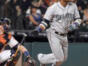 Seattle Mariners' Robinson Cano watches his three-run double in the ninth inning of a baseball game against the Houston Astros, Thursday, May 5, 2016, in Houston.