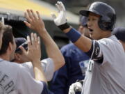 Seattle Mariners&#039; Dae-Ho Lee, right, is congratulated after hitting a two run home run off Oakland Athletics&#039; John Axford in the seventh inning of a baseball game Wednesday, May 4, 2016, in Oakland, Calif.