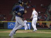 Cincinnati Reds relief pitcher Blake Wood (36) steps up onto the mound after walking Seattle Mariners' Seth Smith with the bases loaded, scoring Leonys Martin, left, during the seventh inning of a baseball game, Friday, May 20, 2016, in Cincinnati.