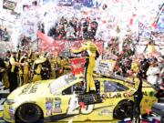 Matt Kenseth, center, celebrates in Victory Lane after he won the NASCAR Sprint Cup series auto race, Sunday, May 15, 2016, at Dover International Speedway in Dover, Del.