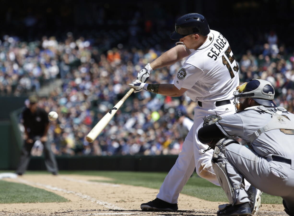 Seattle Mariners&#039; Kyle Seager hits a two-run home run as San Diego Padres catcher Derek Norris looks on in the sixth inning of a baseball game Monday, May 30, 2016, in Seattle.