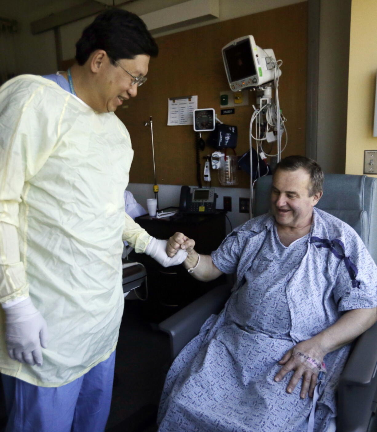 Thomas Manning, right, of Halifax, Mass. clasps hands with Dr. Dicken Ko, director of the urology program at Massachusetts General Hospital, Wednesday, May 18, 2016, in Boston. Manning is the first man in the United States to undergo a penis transplant. Dr. Ko co-led the surgical transplant team.