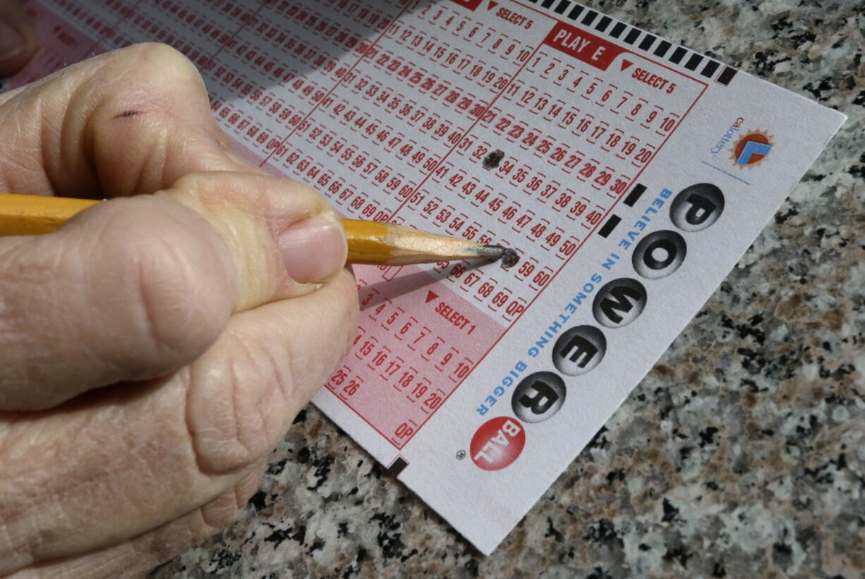 A lottery player fills out numbers on a powerball form in Oakland, Calif. The Powerball jackpot has grown to over 1.5 billion dollars. Only ne ticket matched all six numbers in the drawing Saturday, May 7, for a $429.6 million jackpot, said Powerball spokeswoman Kelly Cripe, and New Jersey lottery officials said Sunday it was sold at a 7-Eleven store in Trenton, N.J.