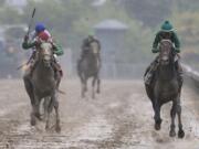 Exaggerator, right, with Kent Desormeaux aboard wins the 141st Preakness Stakes horse race at Pimlico Race Course, Saturday, May 21, 2016, in Baltimore. Cherry Wine, left, with Corey Lanerie aboard places second.